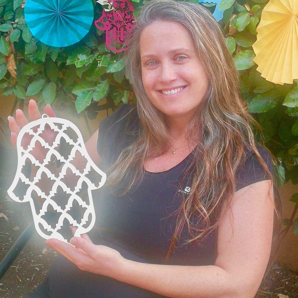 Handmade silver Hamsa wall hanging held by designer – modern Jewish home decor from Israel